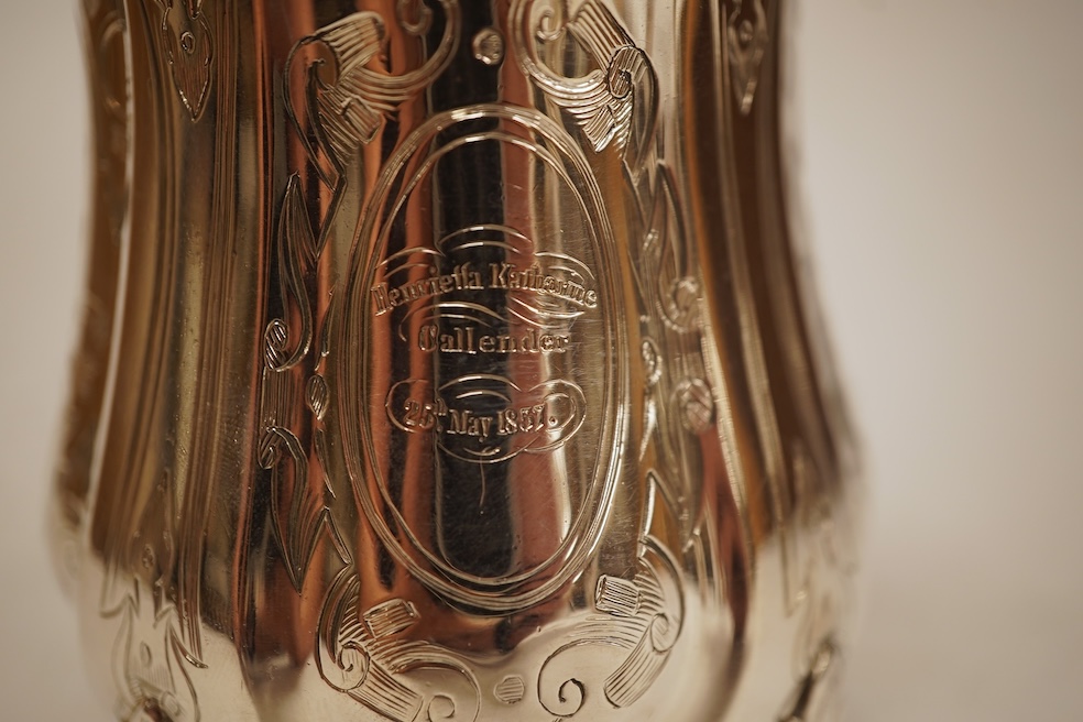 A Victorian engraved silver christening mug, with acanthus leaf capped scroll handle and engraved inscription, Martin, Hall & Co, Sheffield, 1856, 11cm, 5.3oz.